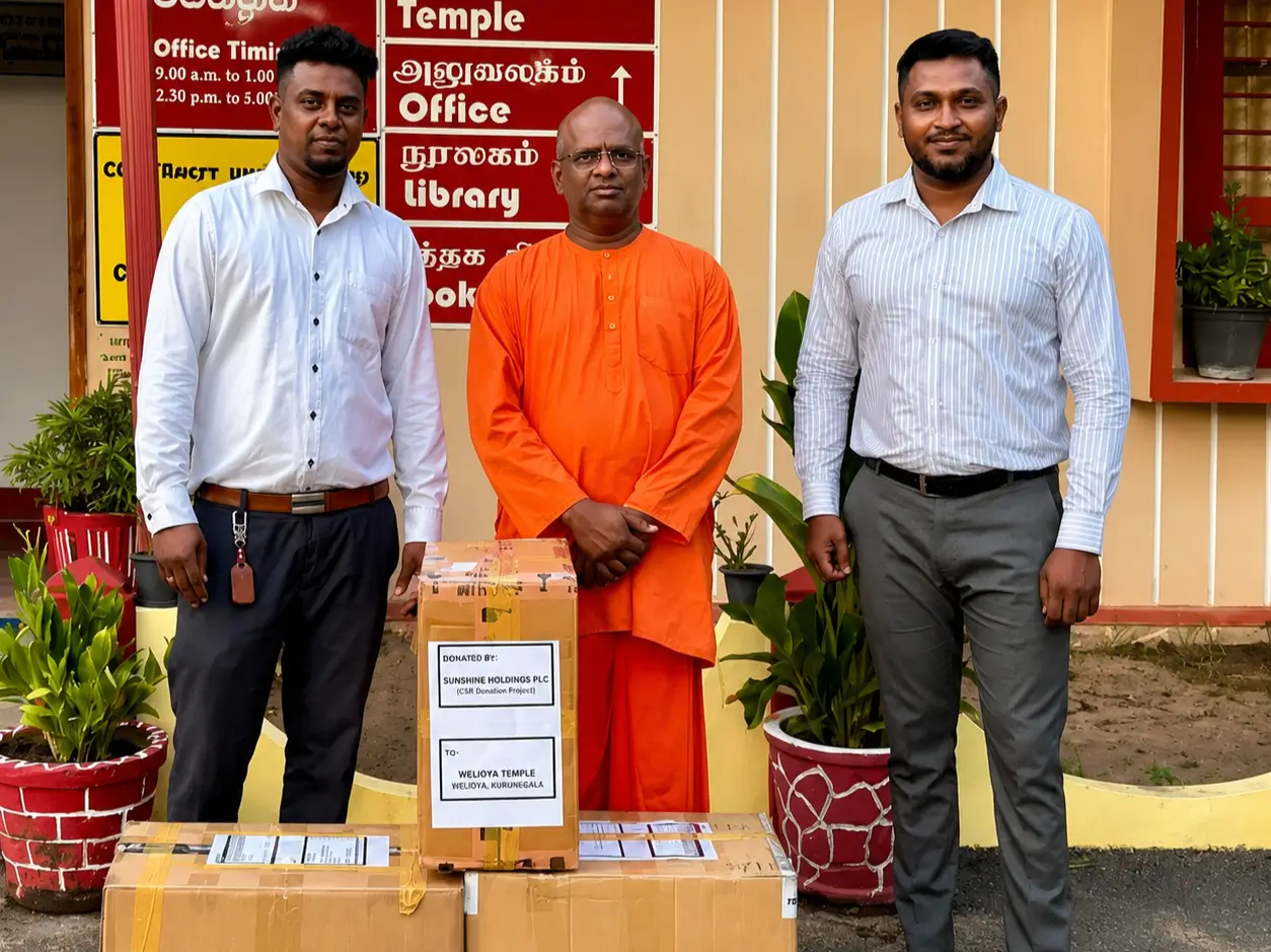 An employee of sunshine holdings presenting an aid box with sunshine logo for suwaseriya ambulance service