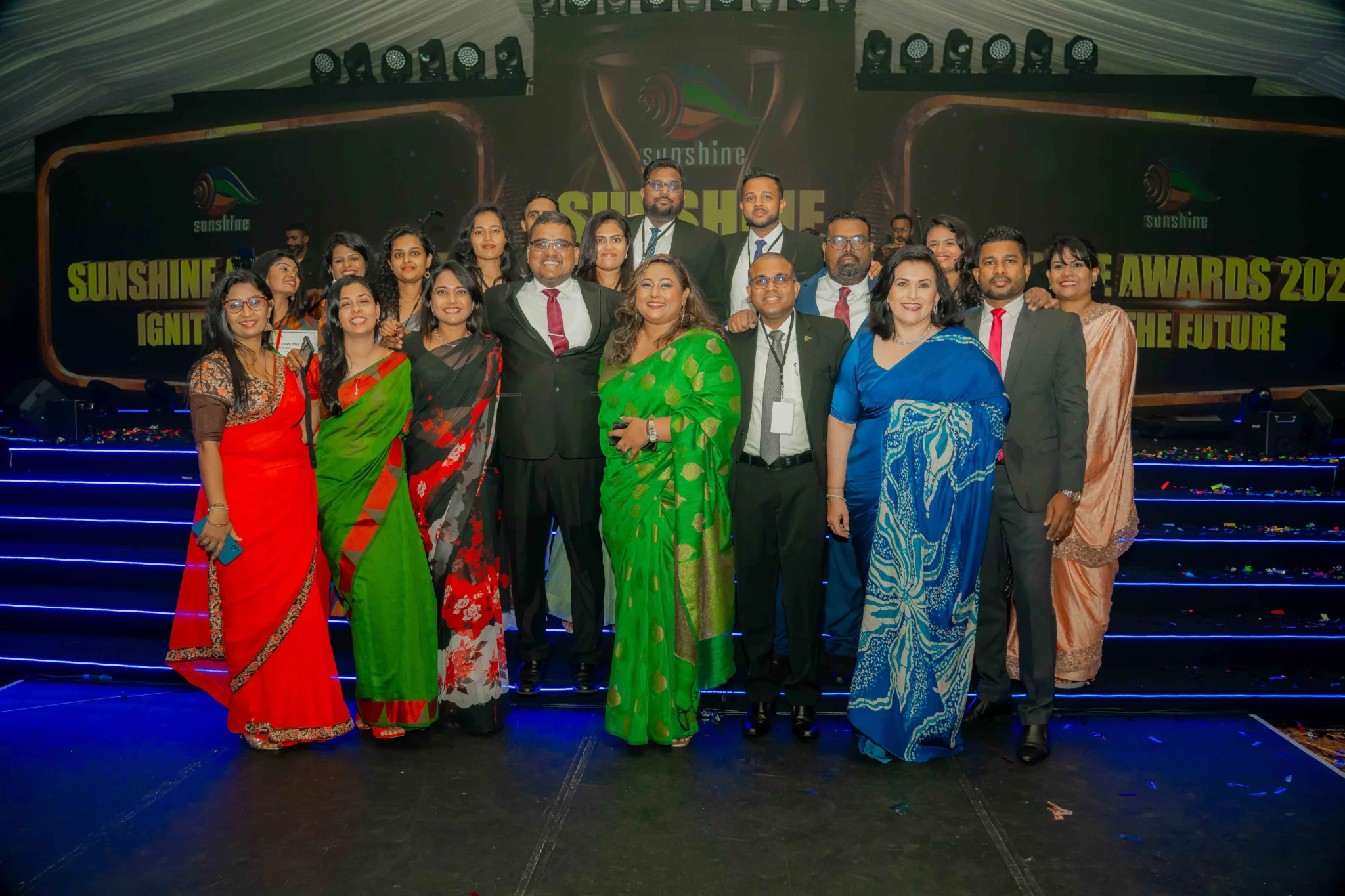 A group of people posing together at the SUN Awards event, celebrating top performers under the theme 'Ignite the Future.