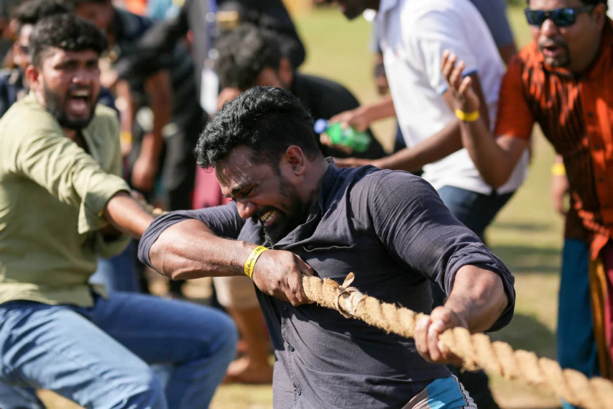A tug of war game played and few other participants are encouring the players