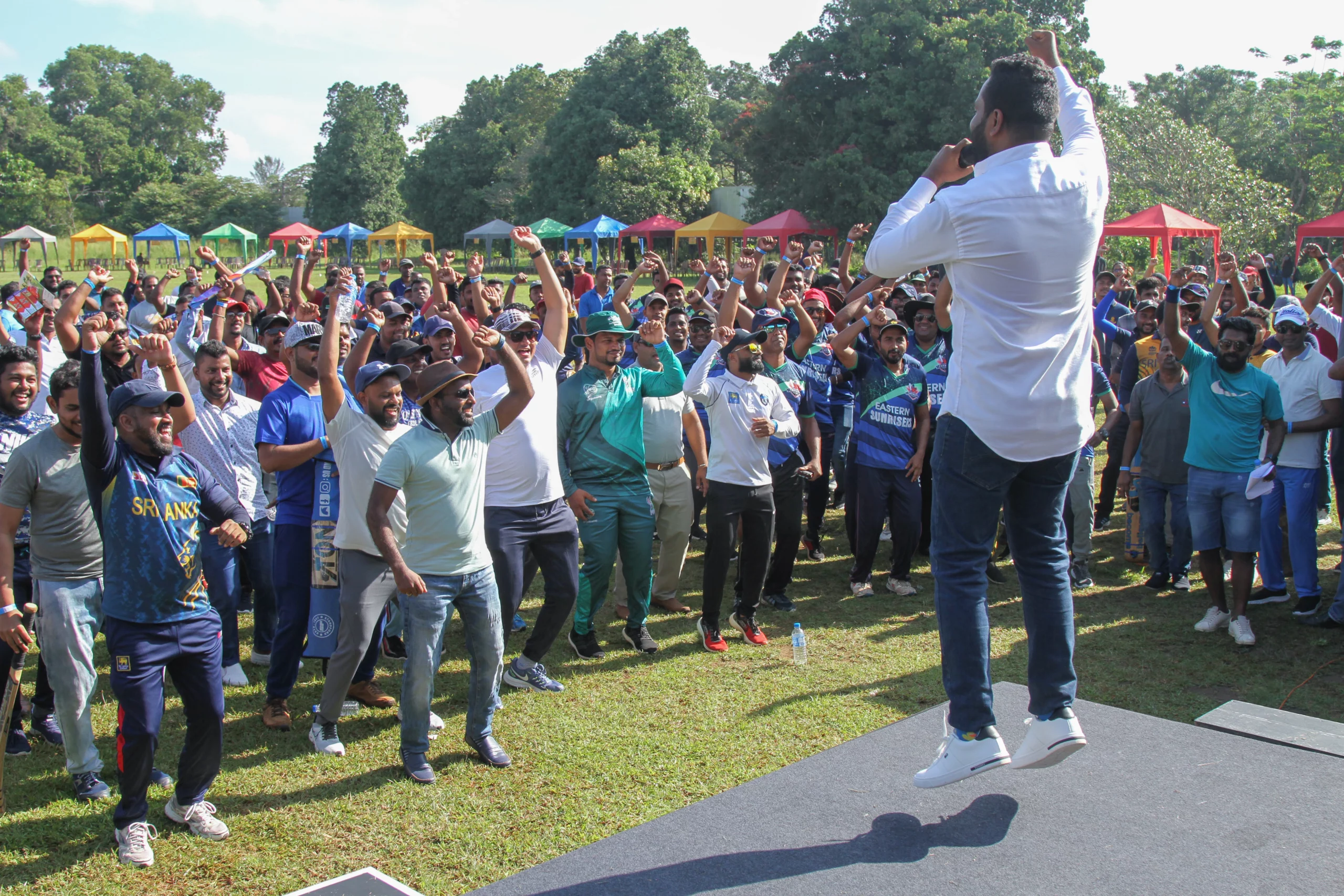 A commentor on the stage motivating the participants in a group meeting